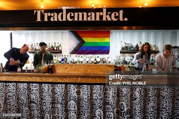 Britain's Prince William, Prince of Wales and Britain's Catherine, Princess of Wales make cocktails during a visit of the Trademarket outdoor market...