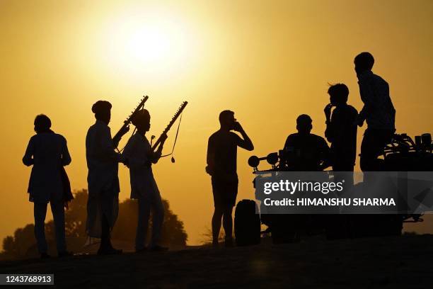 Musicians play traditional instruments for tourists at Pushkar in India's desert state of Rajasthan on October 6, 2022.