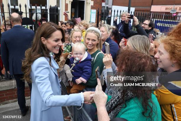 Britain's Catherine, Princess of Wales meets with people during a visit of the Trademarket outdoor market, in Belfast, on October 6, 2022.