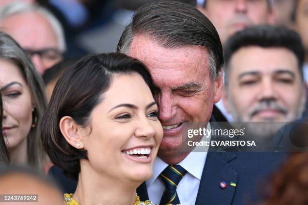 Brazilian first lady Michelle Bolsonaro and Brazilian President and re-election candidate Jair Bolsonaro laugh after a meeting with elected lawmakers...