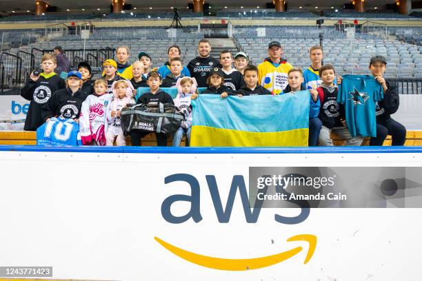 Tomas Hertl of the San Jose Sharks poses for a photo with the Ukrainian Hockey Dream team, after open practice during the NHL Global Series at O2...