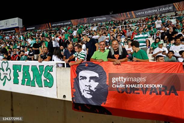 Omonia's fans cheer for their team with a poster depicting late Argentine-born Marxist revolutionary hero Ernesto "Che" Guevara, during the UEFA...