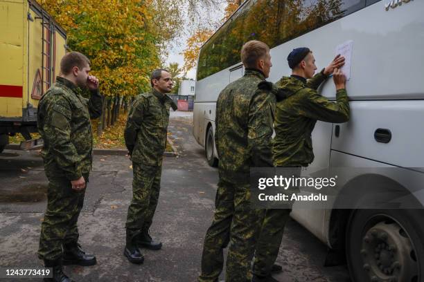 Russian recruits gather outside a military processing center as drafted men said goodbye to their families before departing from their town in...