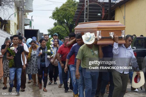 Relatives and friends attend a funeral procession of a person killed in a shooting in San Miguel Totolapan, state of Guerrero, Mexico, on October 6,...