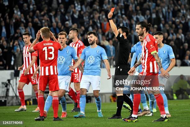 Union Berlin's Hungarian midfielder Andras Schafer is shown the red card for fouling Malm's Danish midfielder Anders Christiansen during the UEFA...