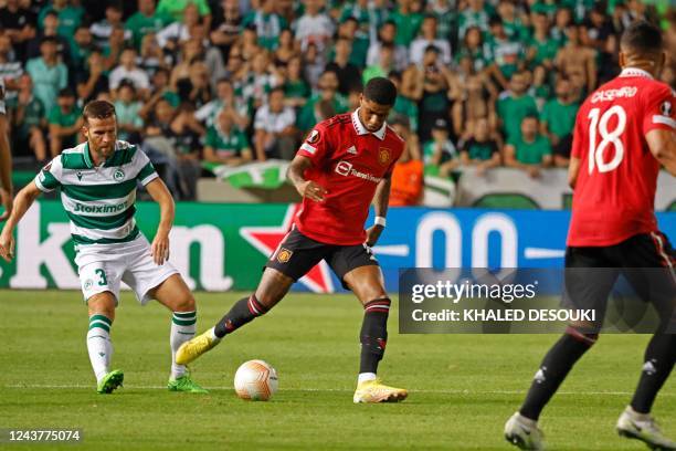 Omonia's Welsh defender Adam Matthews and Manchester United's English striker Marcus Rashford vie for the ball during the UEFA Europa League group E...