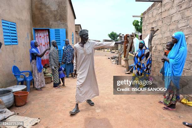 This photograph shows displaced families, who fled Jihadists' attacks in northern and eastern Burkina Faso, in Gampela near Ouagadougou on October 6,...