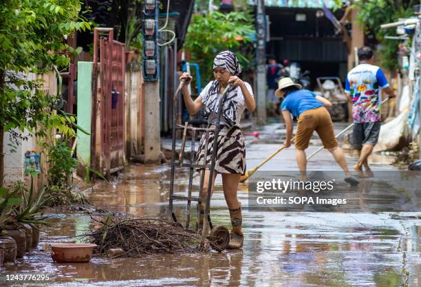 Woman cleans up a house in Chiang Mai's Muang district during the aftermath. The flood situation at Chiang Mai in the northern part of Thailand comes...