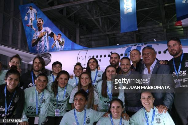 President of the Argentine Football Association, Claudio Tapia , poses with members of the U-20 female football national team next to the Aerolineas...