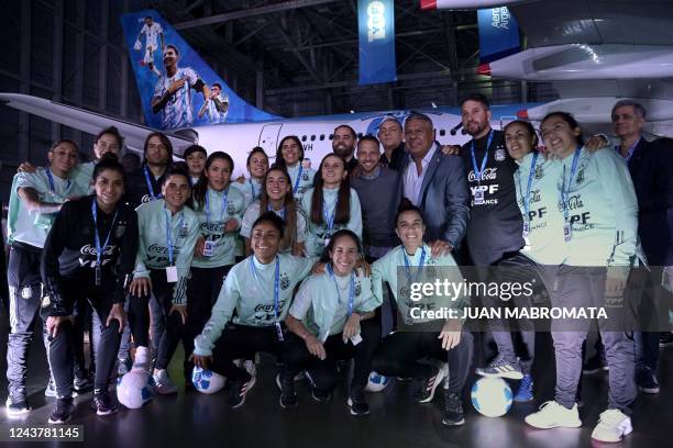 President of the Argentine Football Association, Claudio Tapia , poses with members of the U-20 female football national team next to the Aerolineas...