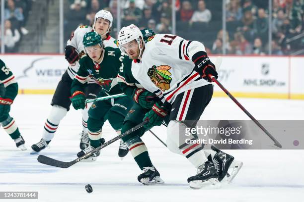 Taylor Raddysh of the Chicago Blackhawks skates with the puck against the Minnesota Wild in the first period of a preseason game at Xcel Energy...