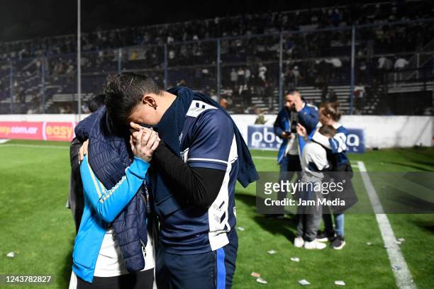 Fans of Gimnasia cover as they are affected by tear gas after a match between Gimnasia y Esgrima La Plata and Boca Juniors was cancelled as part of...