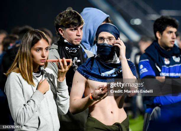 Fans of Gimnasia y Esgrima La Plata reacts after being affected by tear gas after a match between Gimnasia y Esgrima La Plata and Boca Juniors was...