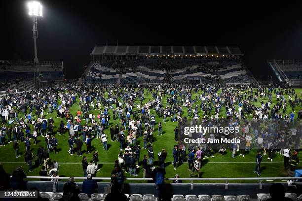 General view as fans of Gimnasia y Esgrima La Plata affected by tear gas enter the field of play after a match between Gimnasia y Esgrima La Plata...