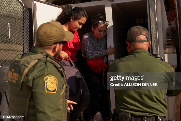 Group of migrants who entered the United States illegally from Mexico are steered into a van by US Border Patrol agents on October 6 in Calexico,...