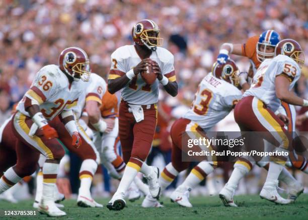 Washington Redskins quarterback Doug Williams looks for a pass during the Super Bowl XXII between Washington Redskins and Denver Broncos at the Jack...