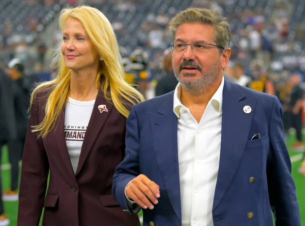 Washington Commanders owners Tanya Snyder, left, and Dan Snyder on the field before the Dallas Cowboys defeat of the Washington Commanders 25-10 at...
