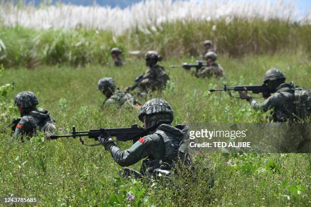 South Korean and US marines take positions during a joint amphibious landing exercise with their Philippine counterparts at a beach facing the South...