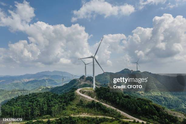 Wind turbines form a windmill array on a green hillside in Nanning, South China's Guangxi Zhuang autonomous region, on Oct 6, 2022.