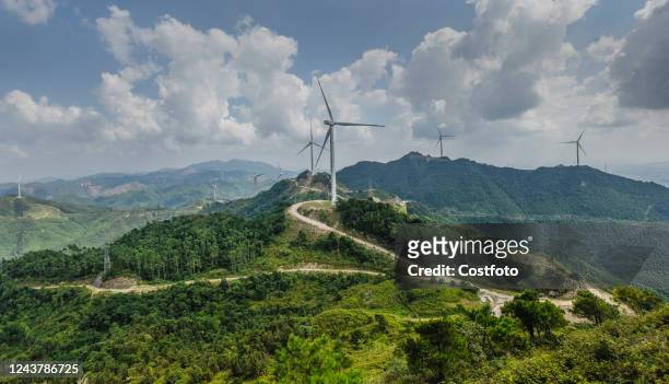 Wind turbines form a windmill array on a green hillside in Nanning, South China's Guangxi Zhuang autonomous region, on Oct 6, 2022.