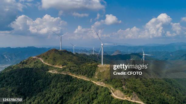 Wind turbines form a windmill array on a green hillside in Nanning, South China's Guangxi Zhuang autonomous region, on Oct 6, 2022.