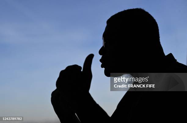 Former French international football player Marcel Desailly is silhouetted as he speaks to media during the FIFA World Cup Trophy Tour in Paris,...