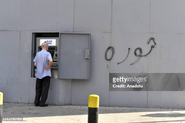 People using a bank atm as banks were closed for more than a week last month following series of holdups by desperate citizens in Beirut, Lebanon on...