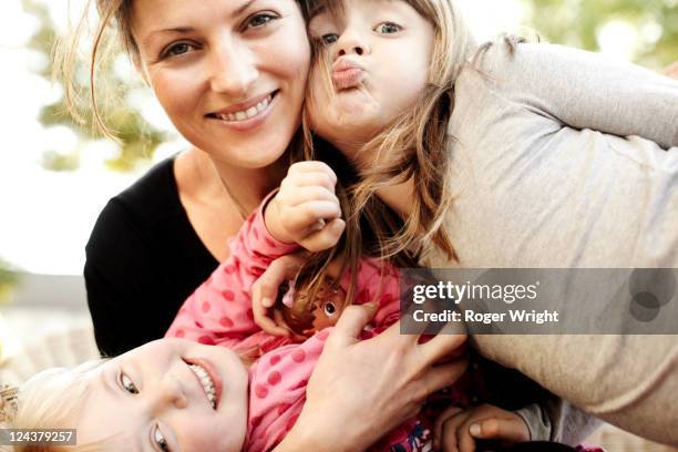 kids - mom puckering lips stock pictures, royalty-free photos & images