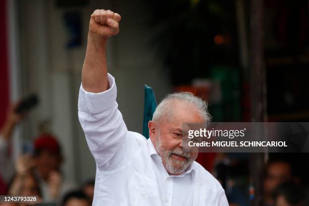 Brazil's former President and presidential candidate for the leftist Workers Party Luiz Inacio Lula da Silva raises his fist to supporters during a...