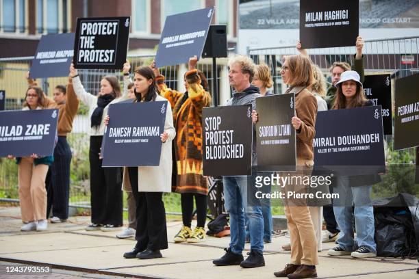 Human rights activists of Amnesty International stage a protest outside the embassy of Iran on October 7, 2022 in The Hague, Netherlands. Human...