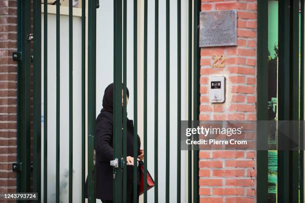 Veiled woman enters the embassy of Iran as human rights activists of Amnesty International stage a protest outside the embassy of Iran on October 7,...