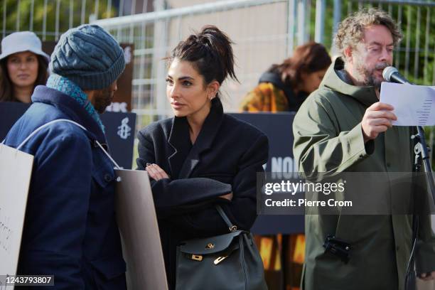 Iranian - Dutch influencer Anna Nooshin speaks with a protester as human rights activists of Amnesty International stage a protest outside the...