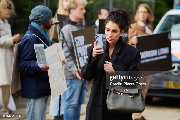 Iranian - Dutch influencer Anna Nooshin takes a foto as human rights activists of Amnesty International stage a protest outside the embassy of Iran...