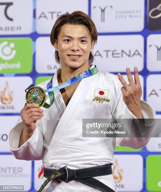 Japan's Hifumi Abe poses after beating compatriot Joshiro Maruyama in the men's 66-kilogram final at the judo world championships in the Uzbekistan's...