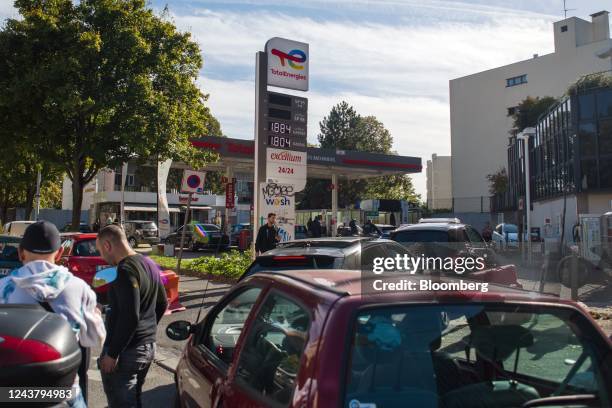 Customers queue for fuel at a TotalEnergies SE gas station on the outskirts of Paris, France, on Friday, Oct. 7, 2022. The French government may...