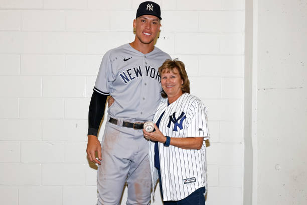 Aaron Judge of the New York Yankees poses for a photograph with his mother, Patty, with the ball he hit to tie Roger Maris American League home run...