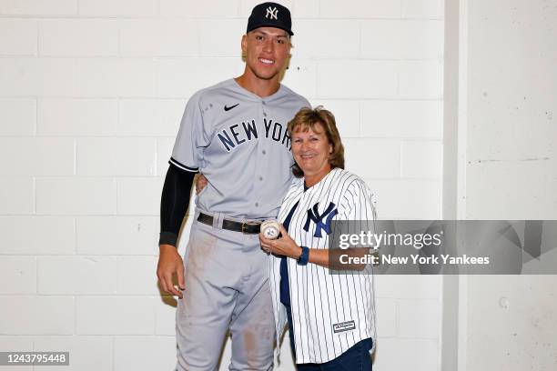 Aaron Judge of the New York Yankees poses for a photograph with his mother, Patty, with the ball he hit to tie Roger Maris American League home run...