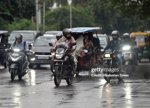 Commuters out in light rain, on October 7, 2022 in Noida, India.