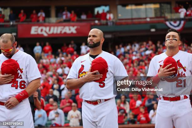 Paul Goldschmidt, Albert Pujols and Lars Nootbaar of the St. Louis Cardinals look on prior to the Wild Card Series game between the Philadelphia...