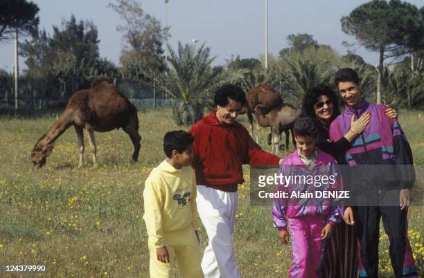 Libyan leader Muammar Gaddafi walks with wife Safia and sons Seif al-Arab, known as Aruba, Khamis and Moatassem-Billah in the military barrackwith...