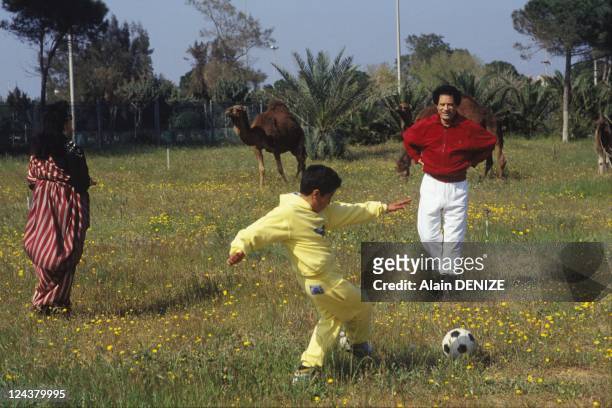 Libyan leader Muammar Gaddafi and his wife Safia look on as their son Seif al-Arab, known as Aruba, plays football in the military barracks of Bab...