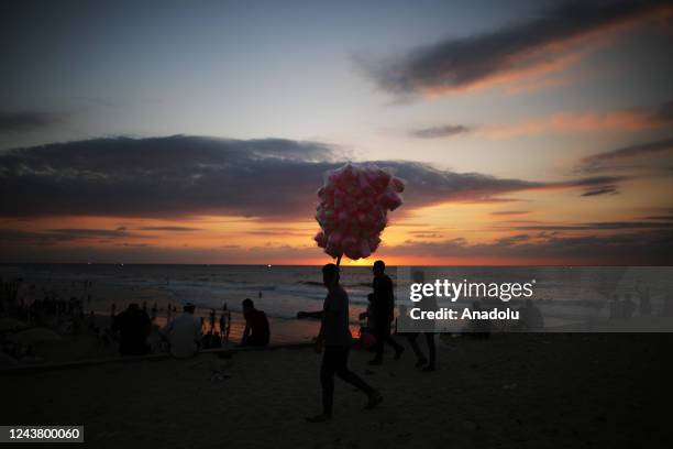 Palestinians enjoy during sunset at the beach in Gaza City, Gaza on October 07, 2022.