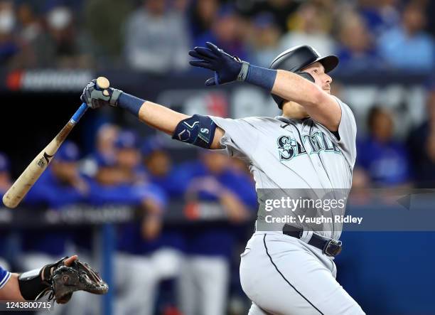 Cal Raleigh of the Seattle Mariners hits a 2 run home run in the first inning during Game One of the AL Wild Card series against the Toronto Blue...