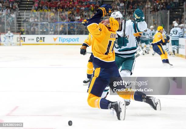Mattias Ekholm of the Nashville Predators falls to the ice after getting checked by Matt Nieto of the San Jose Sharks during the third period of the...