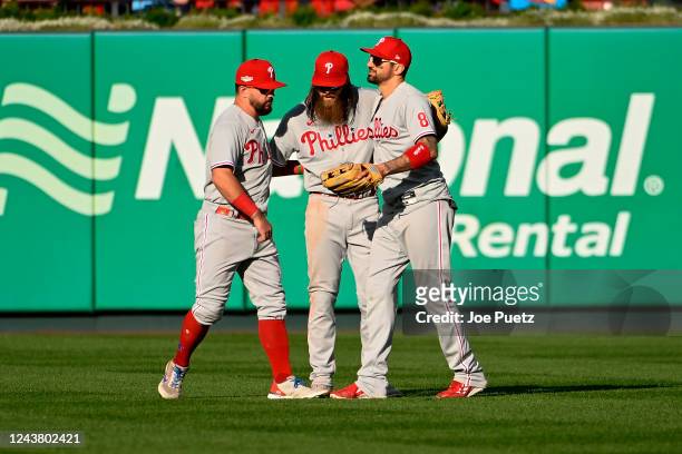 Kyle Schwarber Brandon Marsh and Nick Castellanos of the Philadelphia Phillies celebrate their teams 6-3 victory over the St. Louis Cardinals during...