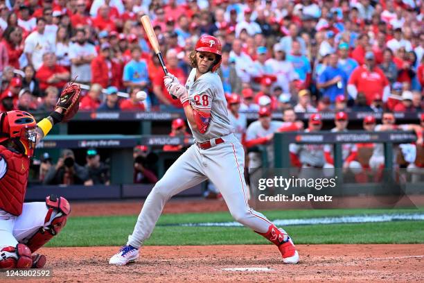 Alec Bohm of the Philadelphia Phillies is hit by a pitch which resulted in a run scored against the St. Louis Cardinals in the ninth inning during...