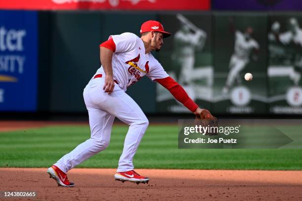 Nolan Arenado of the St. Louis Cardinals is unable to field a ground ball by the Philadelphia Phillies in the ninth inning during Game One of the NL...