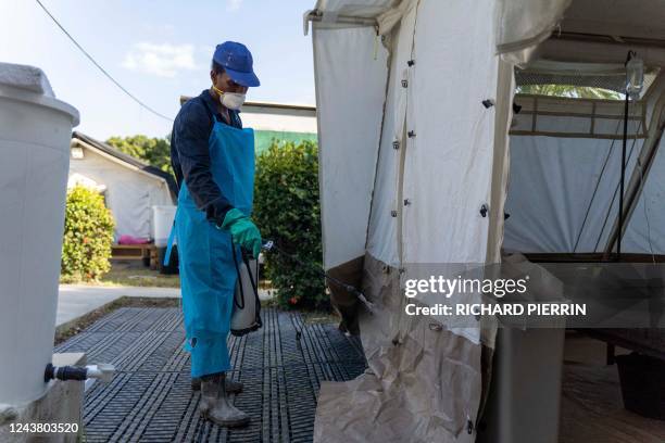 Worker disinfects around a clinic run by Doctors Without Borders where people get treated for cholera, in Cité Soleil a densely populated commune of...