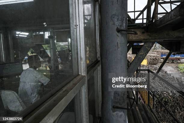 Worker monitors trucks entering Victorias Milling Company Inc. Sugar refinery in Victorias City, Negros Occidental, the Philippines, on Thursday,...
