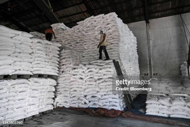 Workers stack sacks of sugar inside Victorias Milling Company Inc. Sugar refinery in Victorias City, Negros Occidental, the Philippines, on Thursday,...